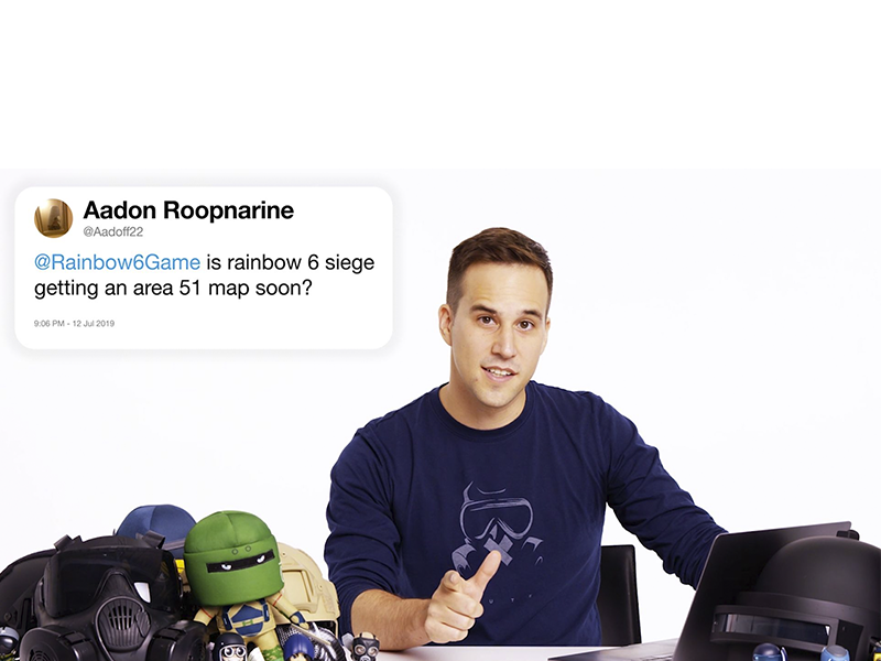 Alexander Karpazis sitting at a desk with toys and a laptop